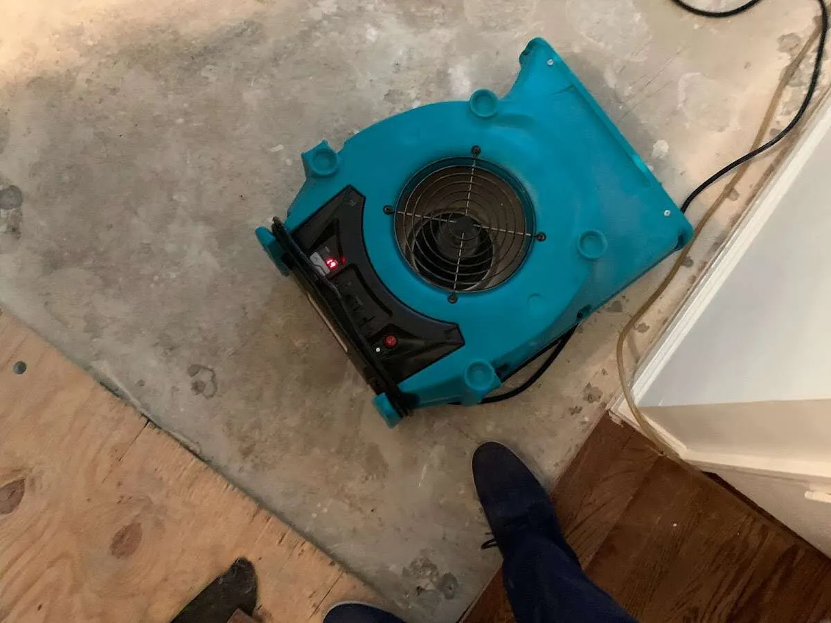 Air mover drying subfloor during Leak Detection & Repair in Oxnard
